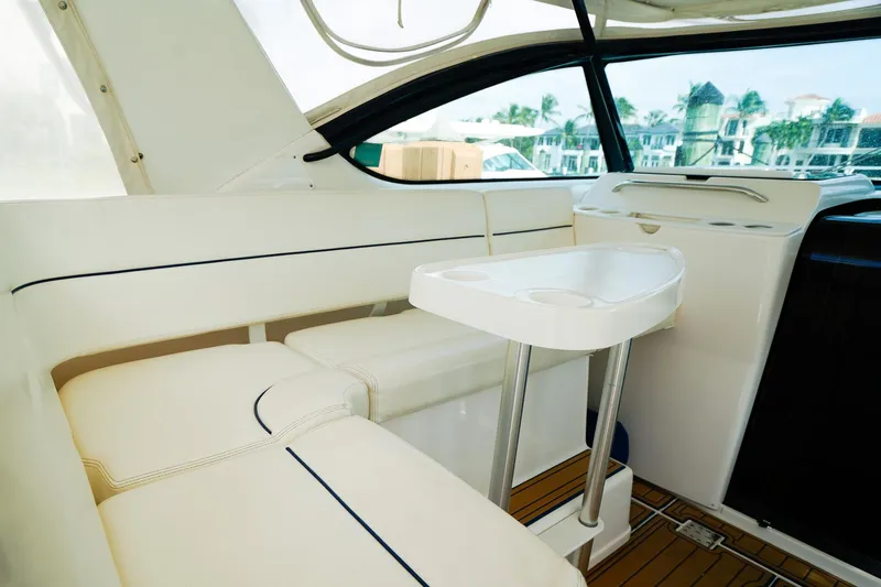 Sommertime Yacht Photos Pics Interior of 2005 Tiara Yachts 3800 Open, featuring white seating and a compact table.