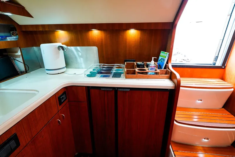 Sommertime Yacht Photos Pics 2005 Tiara Yachts 3800 Open galley with wooden cabinetry, kettle, and countertop storage.