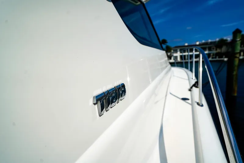 Sommertime Yacht Photos Pics 2005 Tiara Yachts 3800 Open, close-up of logo on sleek white exterior.