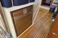 Interior of 2006 Nimbus 350 Coupe with wooden flooring and stainless steel cabinet.