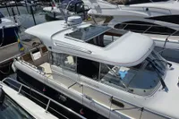 Nimbus 350 Coupe 2006 yacht docked at marina, featuring sleek design and spacious deck.