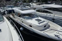 Nimbus 350 Coupe 2006 docked at marina, surrounded by other boats.