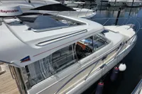 Nimbus 350 Coupe 2006 yacht docked at marina, featuring sleek design and Raymarine equipment.
