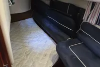 Interior cabin of 2006 Nimbus 350 Coupe with blue seating and white mattress.