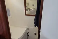 Interior of 2006 Nimbus 350 Coupe bathroom with mirror and sink.