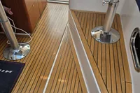 Interior of a 2006 Nimbus 350 Coupe, featuring sleek wooden flooring and modern seating.