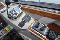 Control panel of a 2006 Nimbus 350 Coupe boat with throttle levers and side power controls.