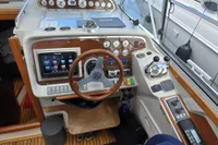 Control panel of a 2006 Nimbus 350 Coupe boat with steering wheel and navigation instruments.