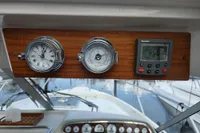 Dashboard of 2006 Nimbus 350 Coupe with clock, barometer, and digital display.