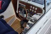 Interior view of a 2006 Nimbus 350 Coupe boat cockpit with steering wheel and controls.