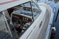 Nimbus 350 Coupe 2006 boat docked, showcasing sleek design and detailed cockpit controls.