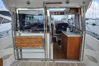 Interior view of 2006 Nimbus 350 Coupe yacht with wooden deck and kitchenette.