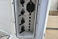 Control panel on a 2006 Nimbus 350 Coupe boat, featuring various switches and heater control.