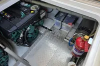 Engine compartment of a 2006 Nimbus 350 Coupe with fire extinguisher and storage boxes.