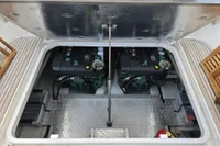 Engine compartment of a 2006 Nimbus 350 Coupe, showcasing dual engines and metallic flooring.