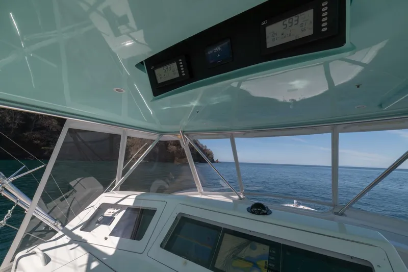 Scandaloso Yacht Photos Pics Helm of 2006 Viking 56 yacht with ocean view and navigation instruments.