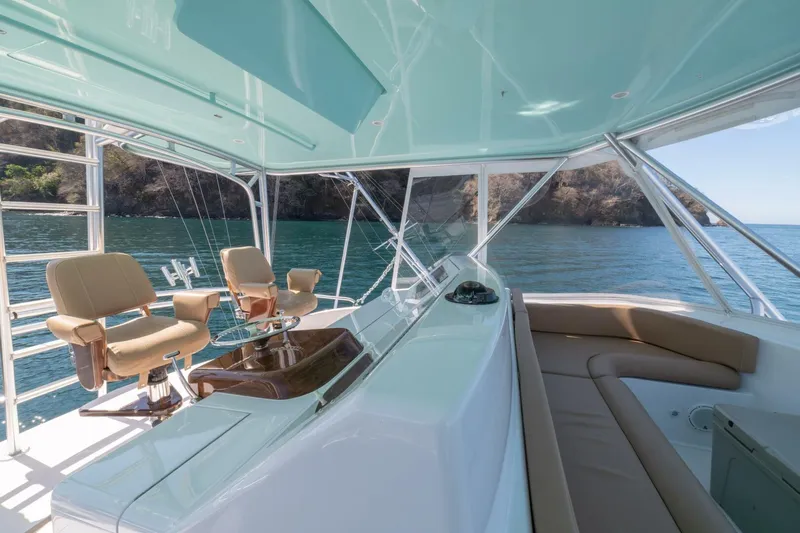 Scandaloso Yacht Photos Pics Luxurious 2006 Viking 56 yacht interior with ocean view and comfortable seating.