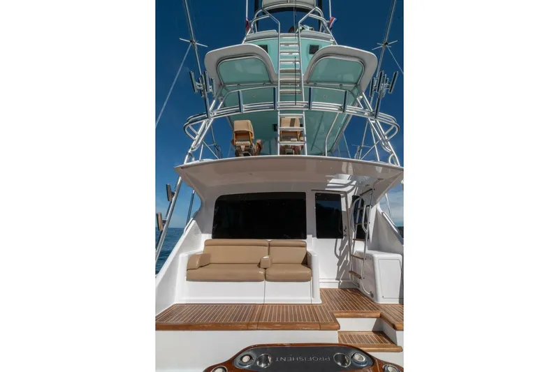 Scandaloso Yacht Photos Pics 2006 Viking 56 yacht with tower, featuring a spacious deck and seating area.