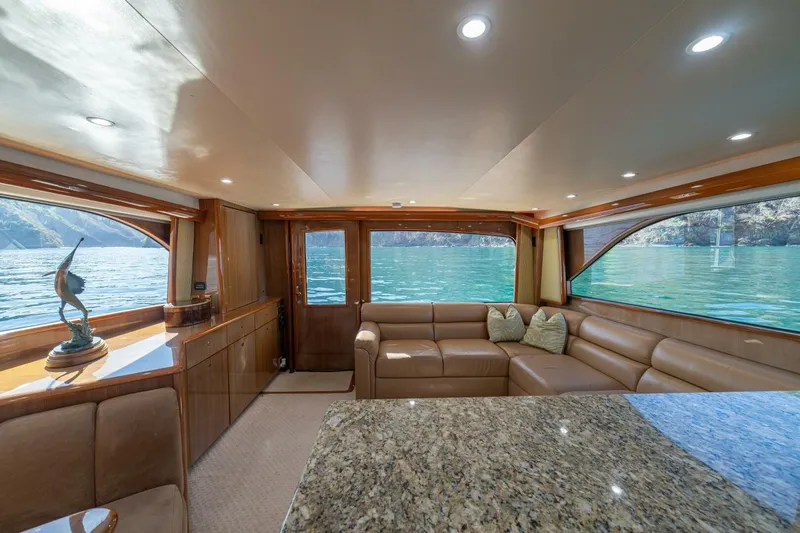 Scandaloso Yacht Photos Pics Luxurious interior of 2006 Viking 56 yacht with leather seating and scenic water views.