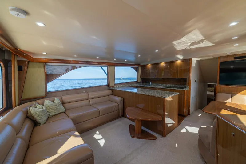 Scandaloso Yacht Photos Pics Luxurious interior of 2006 Viking 56 yacht with leather seating and ocean view.