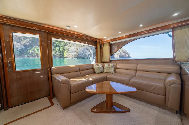 Scandaloso Yacht Photos Pics Luxurious interior of 2006 Viking 56 yacht with leather seating and scenic ocean view.