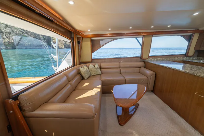 Scandaloso Yacht Photos Pics Luxurious interior of 2006 Viking 56 yacht with leather seating and ocean view.
