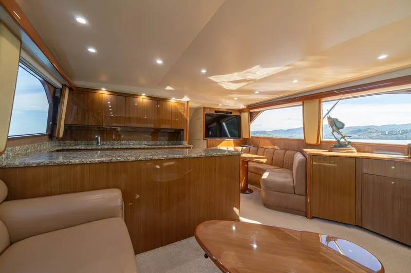 Scandaloso Yacht Photos Pics Luxurious interior of 2006 Viking 56 yacht with elegant wood finishes and panoramic windows.