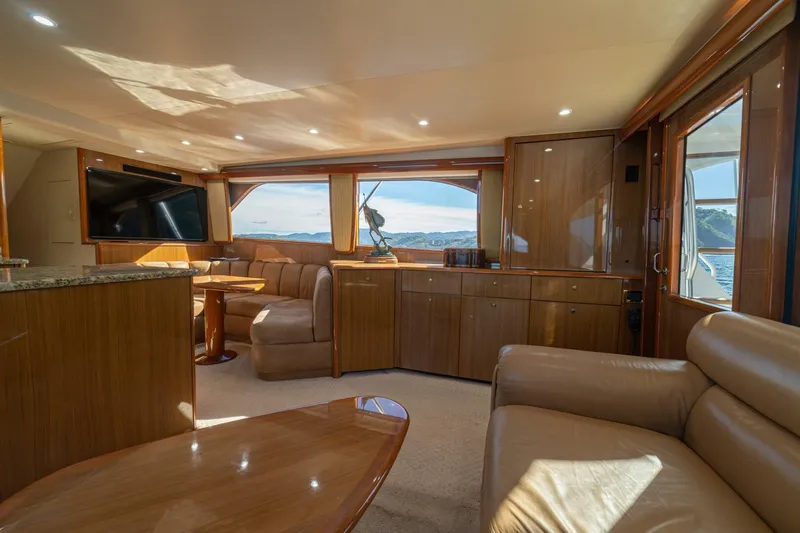 Scandaloso Yacht Photos Pics Luxurious interior of 2006 Viking 56 yacht with leather seating and panoramic windows.