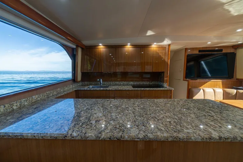 Scandaloso Yacht Photos Pics Luxurious 2006 Viking 56 yacht interior with granite countertops and ocean view.