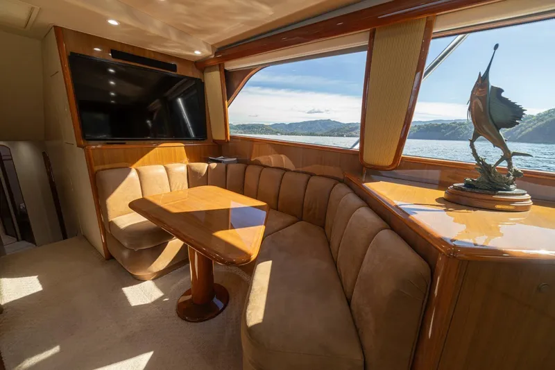 Scandaloso Yacht Photos Pics Luxurious interior of 2006 Viking 56 yacht with plush seating and scenic window view.