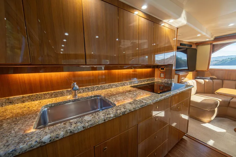 Scandaloso Yacht Photos Pics Luxurious 2006 Viking 56 yacht interior with elegant wood cabinetry and granite countertops.