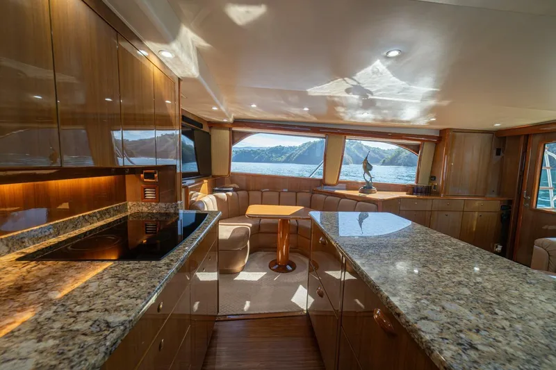 Scandaloso Yacht Photos Pics Luxurious interior of a 2006 Viking 56 yacht with elegant wood finishes and scenic views.