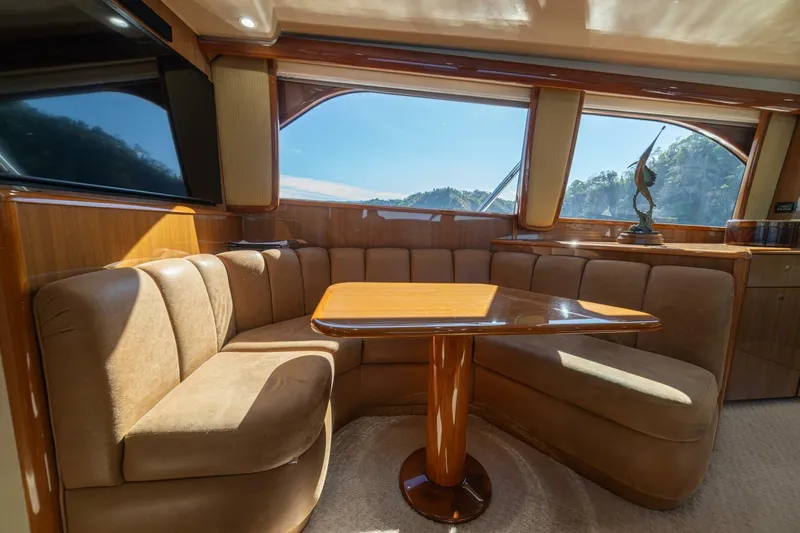 Scandaloso Yacht Photos Pics Luxurious interior of a 2006 Viking 56 yacht with plush seating and scenic windows.