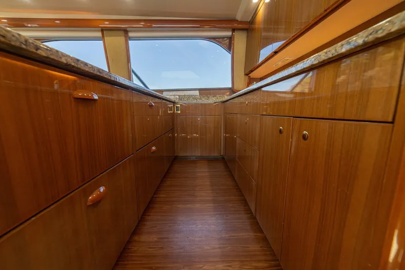 Scandaloso Yacht Photos Pics Luxurious wooden interior of a 2006 Viking 56 yacht kitchen with ample cabinetry.