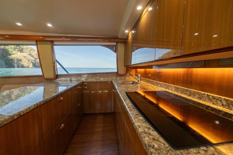 Scandaloso Yacht Photos Pics Luxurious kitchen interior of 2006 Viking 56 yacht with granite countertops and ocean view.