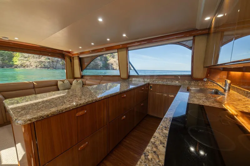 Scandaloso Yacht Photos Pics Luxurious interior of 2006 Viking 56 yacht with granite countertops and scenic ocean view.