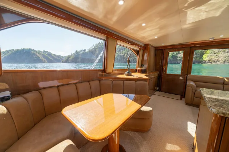 Scandaloso Yacht Photos Pics Luxurious interior of 2006 Viking 56 yacht with scenic ocean view through large windows.