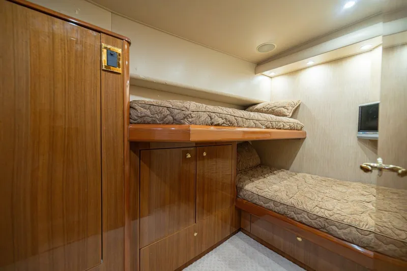 Scandaloso Yacht Photos Pics Luxurious 2006 Viking 56 yacht cabin with wooden bunk beds and ambient lighting.