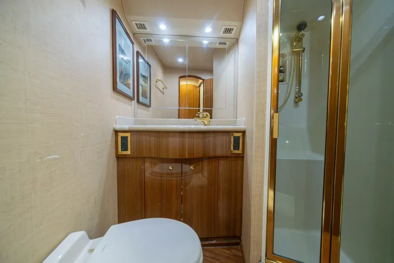 Scandaloso Yacht Photos Pics Luxurious bathroom in 2006 Viking 56 yacht with wood cabinetry and gold accents.
