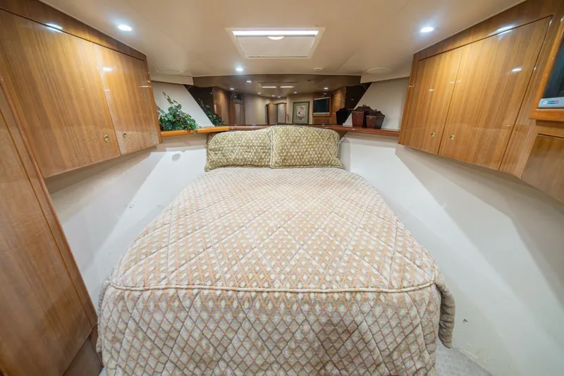 Scandaloso Yacht Photos Pics Luxurious cabin interior of a 2006 Viking 56 yacht with elegant wood cabinetry.