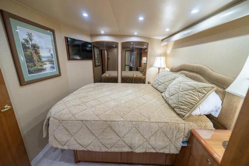 Scandaloso Yacht Photos Pics Luxurious bedroom interior of 2006 Viking 56 yacht with elegant decor and cozy bedding.