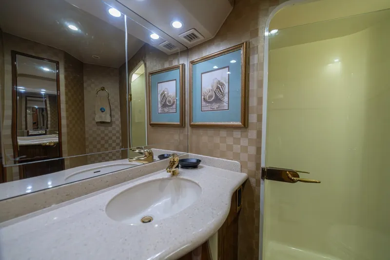Scandaloso Yacht Photos Pics Luxurious bathroom in 2006 Viking 56 yacht with elegant decor and modern fixtures.
