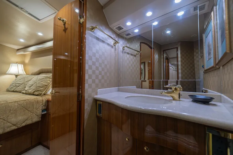 Scandaloso Yacht Photos Pics Luxurious 2006 Viking 56 yacht interior with elegant bedroom and modern bathroom amenities.