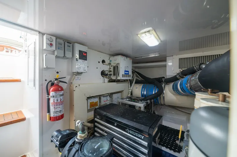 Scandaloso Yacht Photos Pics Engine room of a 2006 Viking 56 yacht with equipment and fire extinguisher.