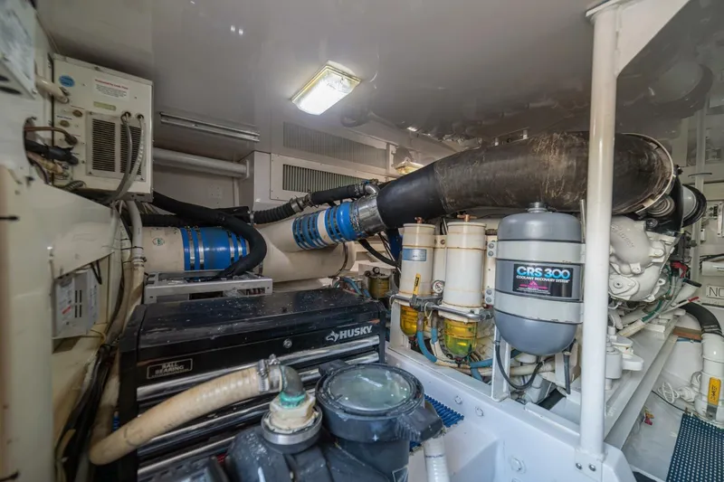 Scandaloso Yacht Photos Pics Engine room of a 2006 Viking 56 yacht, featuring complex machinery and piping.