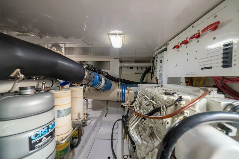 Scandaloso Yacht Photos Pics Engine room of a 2006 Viking 56 yacht, showcasing mechanical components and control panels.