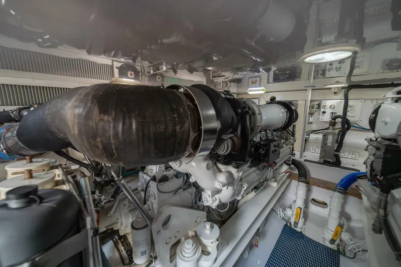 Scandaloso Yacht Photos Pics Engine room of a 2006 Viking 56 yacht, showcasing complex machinery and components.