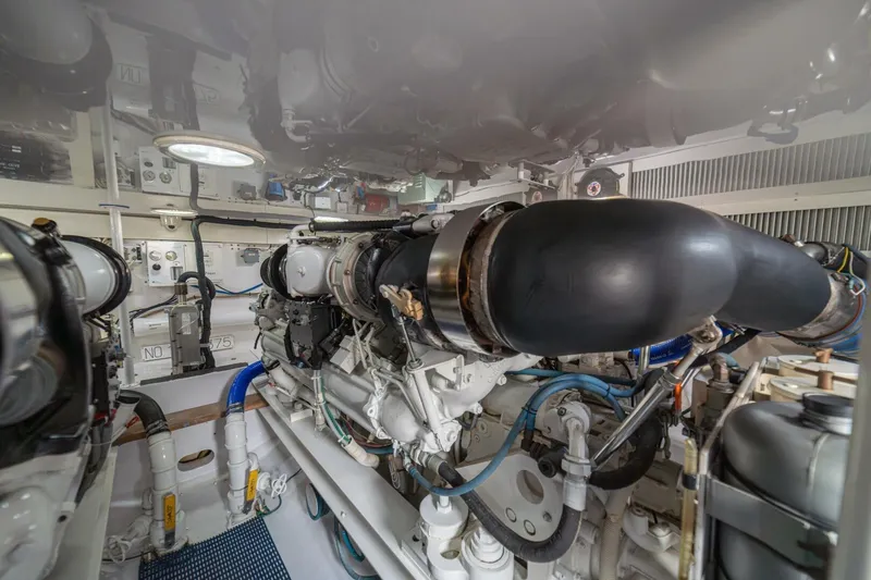 Scandaloso Yacht Photos Pics Engine room of a 2006 Viking 56 yacht, showcasing complex machinery and components.