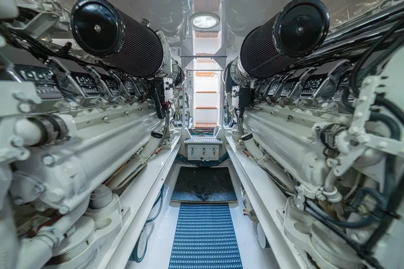 Scandaloso Yacht Photos Pics Engine room of a 2006 Viking 56 yacht, showcasing dual engines and mechanical components.