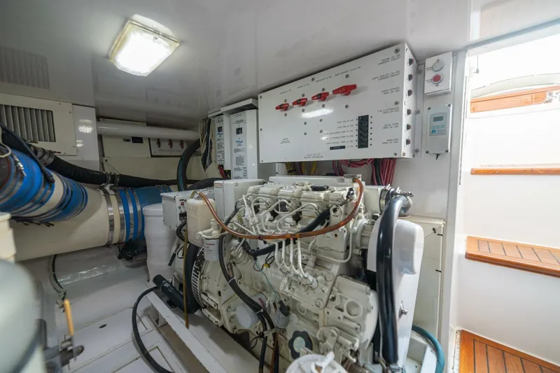 Scandaloso Yacht Photos Pics Engine room of a 2006 Viking 56 yacht, featuring machinery and control panels.